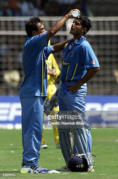 Robin Singh of India pours water over team mate Saurav Ganguly, during the 5th One Day International between India and Australia at the Nehru...
