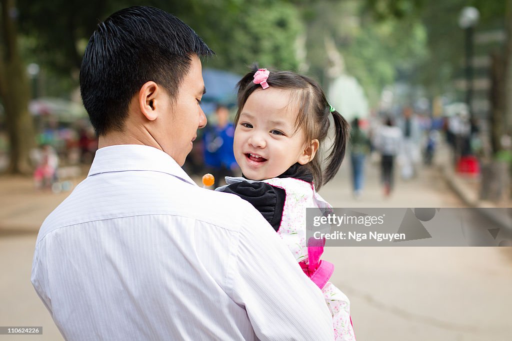 Father takes little daughter to park