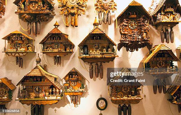 wall display of cookoo clocks - cuckoo clock stock pictures, royalty-free photos & images