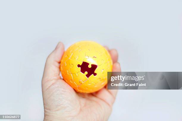 gold puzzle ball. - missing jigsaw piece stock pictures, royalty-free photos & images