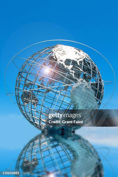 huge globe reflected in pond. - queensday stock-fotos und bilder