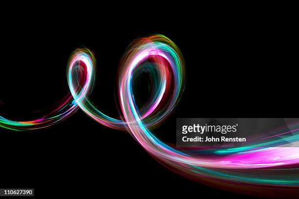 abstract coloured light energy motion trails - lichtspur stock-fotos und bilder