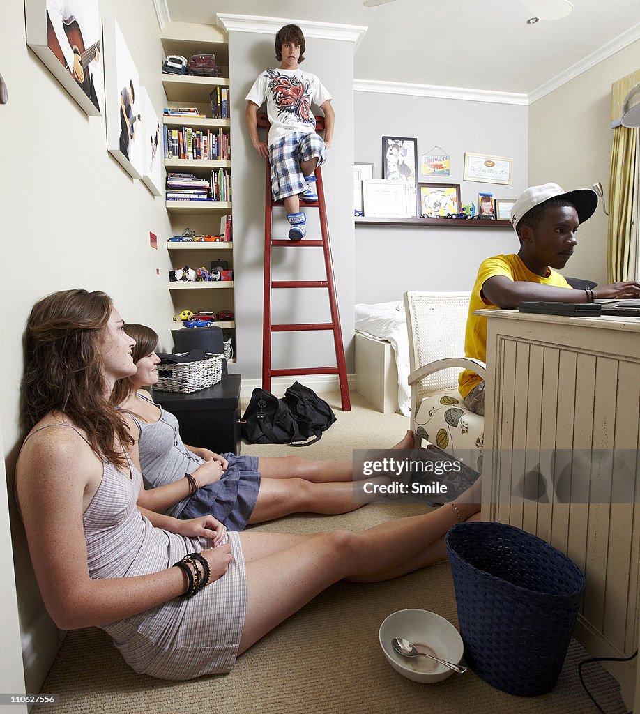 Teen friends hanging out in bedroom