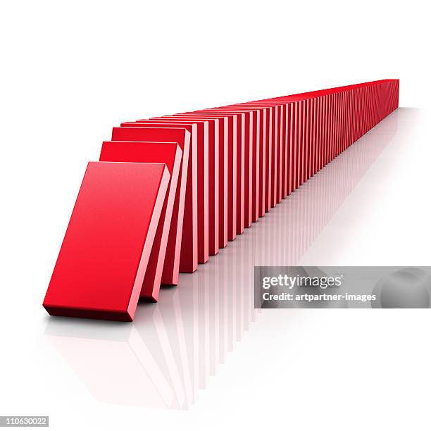 falling dominoes in a chain reaction on white - dominó fotografías e imágenes de stock