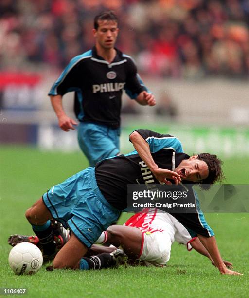 April 2001. Ruud Van Nistelrooy of PSV Eindhoven is tackled by Abubakari Yakubu of Ajax, during the league match between Ajax and PSV at the...