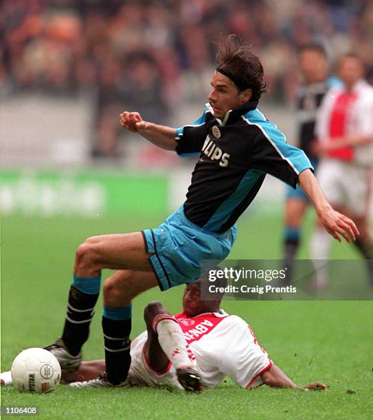 April 2001. Ruud Van Nistelrooy of PSV Eindhoven is tackled by Abubakari Yakubu of Ajax, during the league match between Ajax and PSV at the...