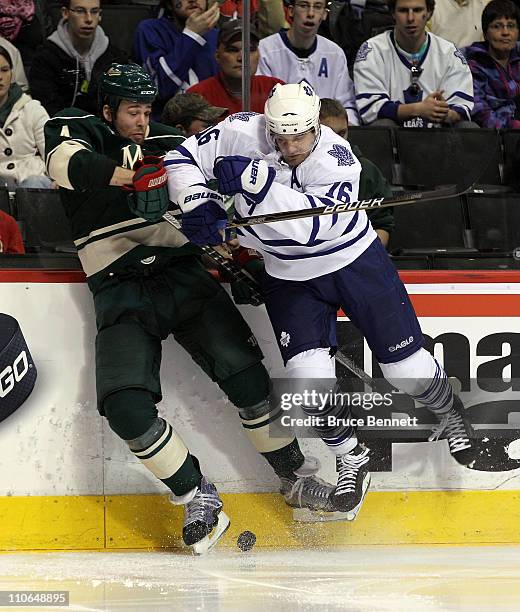 Clayton Stoner of the Minnesota Wild is run into by Clarke MacArthur of the Toronto Maple Leafs at the Xcel Energy Center on March 22, 2011 in St...