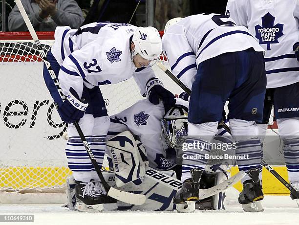 Tim Brent and Luke Schenn of the Toronto Maple Leafs congratulate James Reimer on his 3-0 shutout over the Minnesota Wild at the Xcel Energy Center...