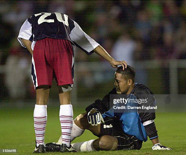 Nicky Salapu of American Samoa is comforted by team mate Young Im Min after they were beaten 31 to nil by Australia which is a new world record...