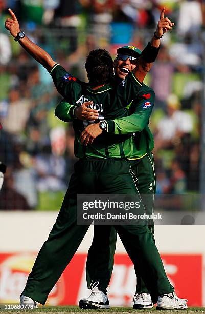 Shahid Afridi of Pakistan celebrates with team mate Misbah-ul-Haq after taking wicket of Devon Thomas of West Indies during the 1st quarterfinal of...