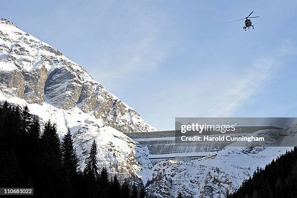 Helicopter flies next to the Grande Dixence Dam on March 22, 2011 in Heremence, Switzerland. Opened in 1965 after 15 years of construction, measuring...