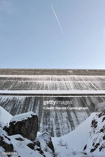 Plane flies above to the Grande Dixence Dam on March 22, 2011 in Heremence, Switzerland. Opened in 1965 after 15 years of construction, measuring 285...