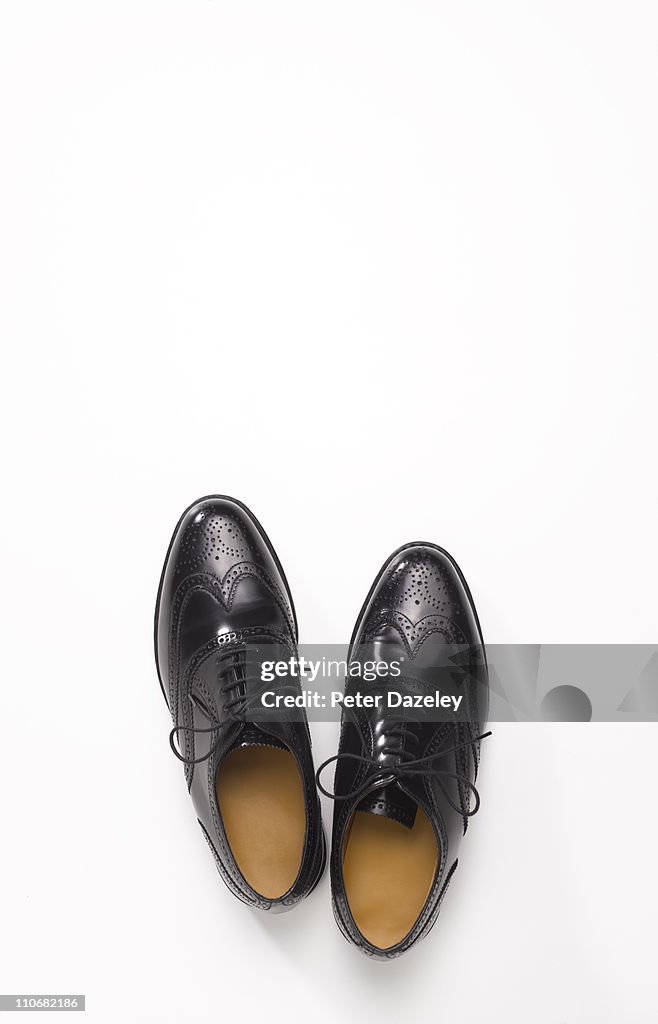 Pair of black brogue shoes with copy space