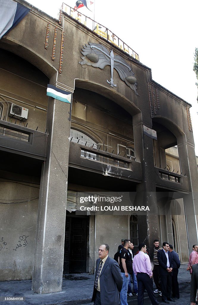 Syrian men gather outside the courthouse