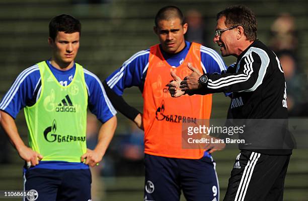 Head coach Ralf Rangnick gives instructions to Alexander Baumjohann and Edu during a FC Schalke 04 training session at Parkstadium on March 23, 2011...
