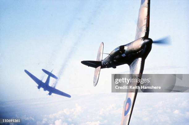 An optically merged image of a Heinkel bomber under attack from a Hawker Hurricane fighter over England, made after aerial shots were filmed for...