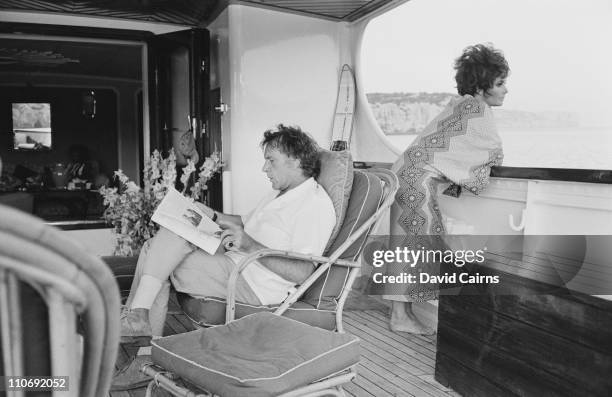 Actor Richard Burton with his wife, actress Elizabeth Taylor , relaxing on their yacht 'Kalizma', off the coast of Capo Caccia in Sardinia, during...