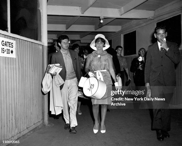 Elizabeth Taylor, escorted by husband Eddie Fisher, arrives at International Airport from Los Angeles. Apparently fully recovered from near fatal...