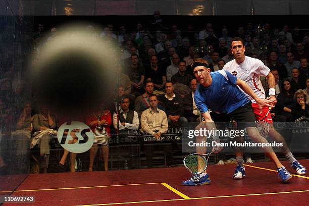 Stuart Boswell of Australia and Peter Barker of England in action during the Quarter Final match in the ISS Canary Wharf Squash Classic at East...