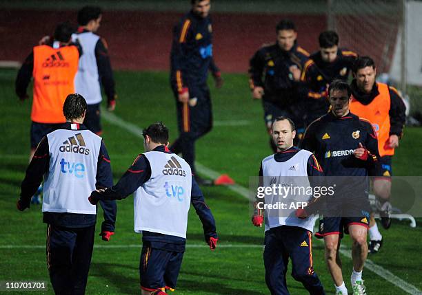 Spain's midfielder Andres Iniesta jogs with teammates during a team training session in Las Rozas, near Madrid, on March 23, 2011. Spain will face...