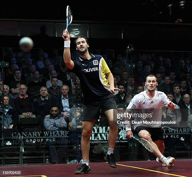 Simon Rosner of Germany and Gregory Gaultier of France in action during their Quarter Final match in the ISS Canary Wharf Squash Classic at East...