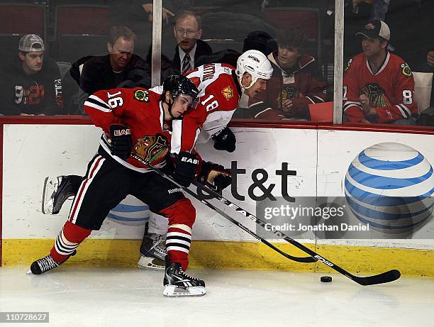 Marcus Kruger of the Chicago Blackhawks battles for the puck with Shawn Matthias of the Florida Panthers at the United Center on March 23, 2011 in...