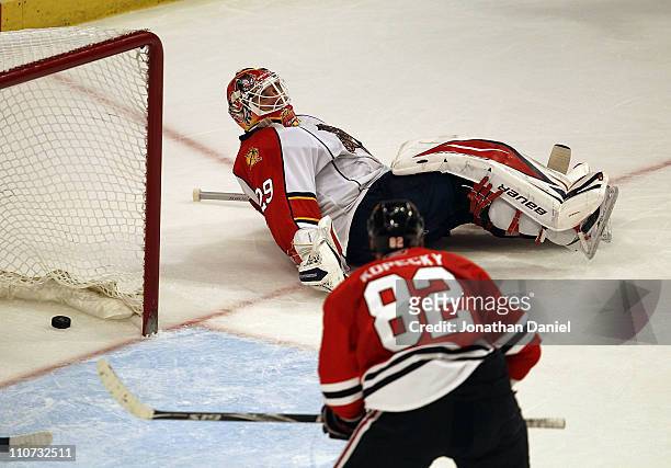 Tomas Kopecky of the Chicago Blackhawks watches the puck go into the net as Tomas Vokoun of the Florida Panthers lays on the ice out of the crease at...