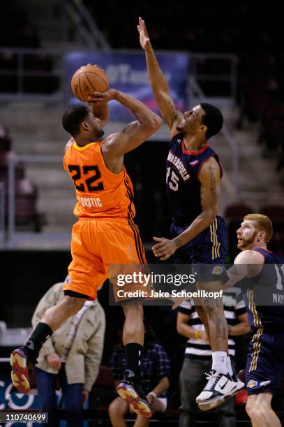 Josh Bostic of the New Mexico Thunderbirds goes to shoot over the defense of Trey Johnson of the Bakersfield Jam as Drew Naymick of the Jam looks on...