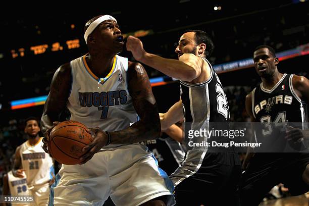 Al Harrington of the Denver Nuggets looks to take a shot against Manu Ginobili of the San Antonio Spurs at the Pepsi Center on March 23, 2011 in...