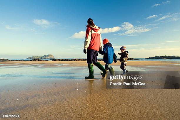 family stroll on beach - east lothian stock pictures, royalty-free photos & images