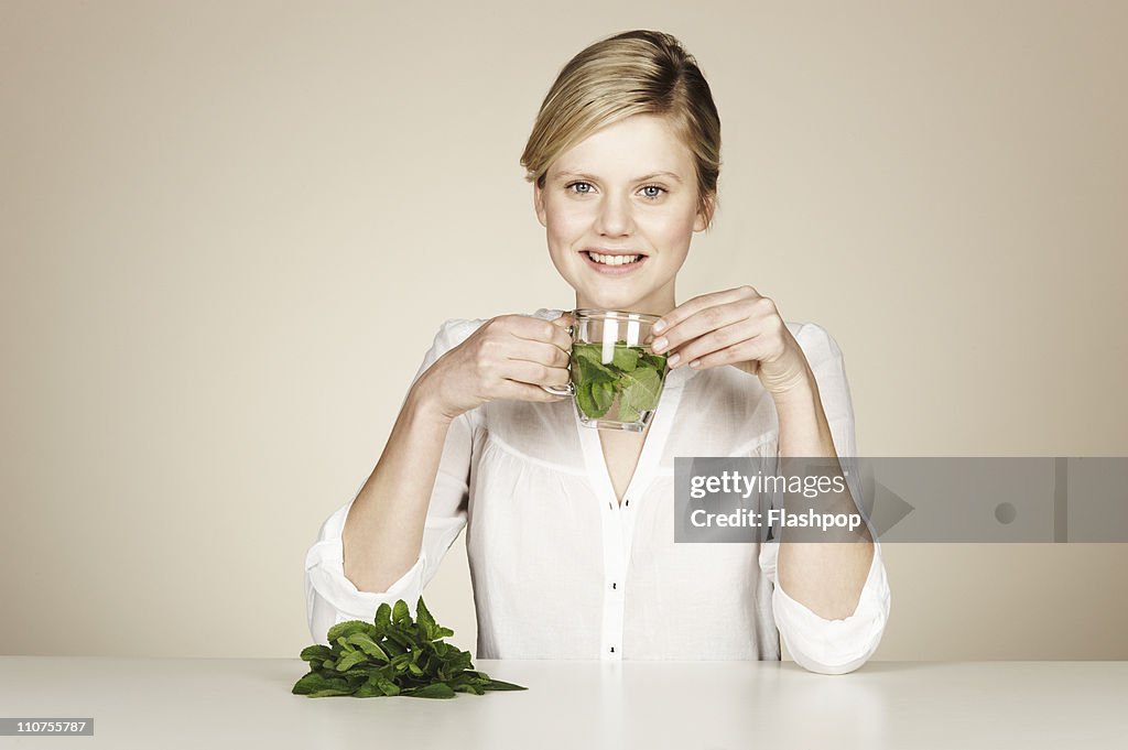 Woman drinking water with fresh mint