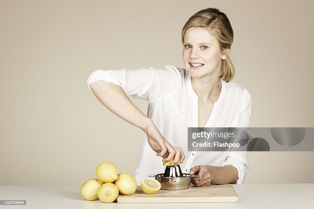 Woman juicing fresh lemons