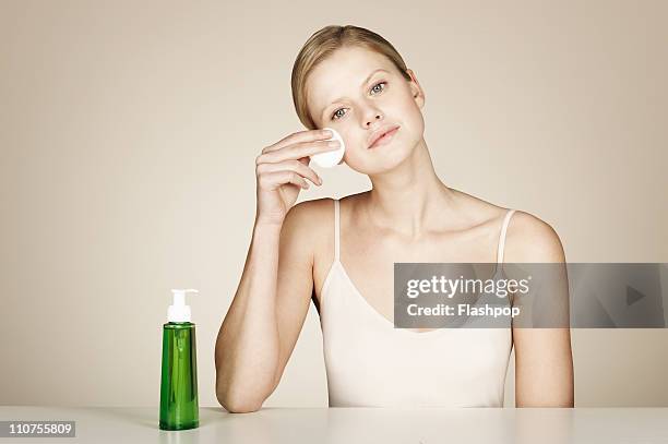 woman using face cleanser - facial cleanser stockfoto's en -beelden