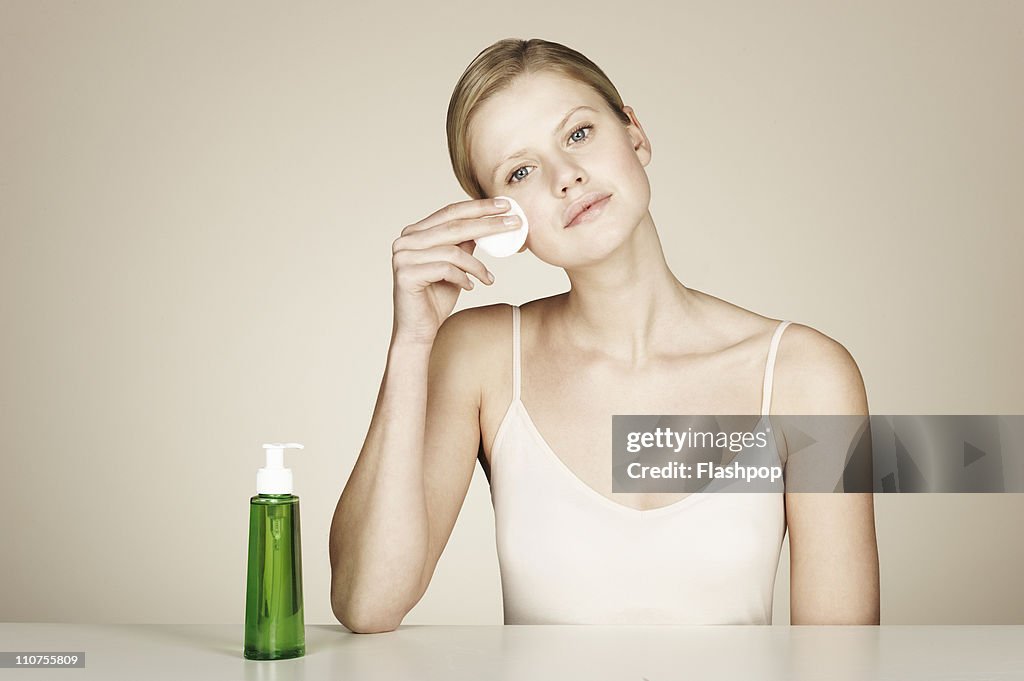 Woman using face cleanser