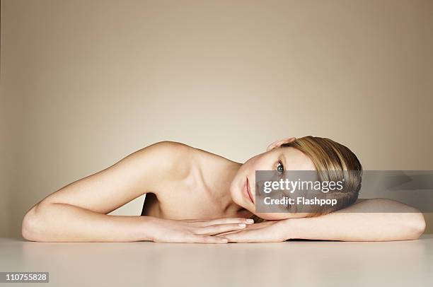 portrait of woman resting - leaning on elbows stock pictures, royalty-free photos & images