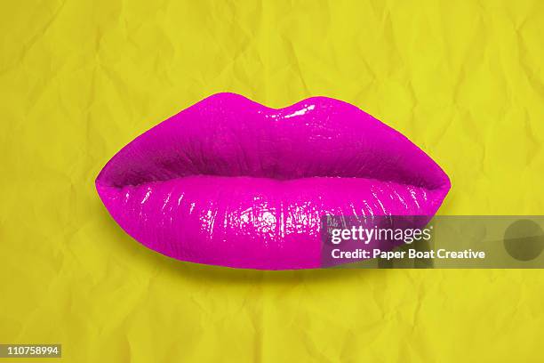 bright pink lips against a yellow paper background - candy lips stock pictures, royalty-free photos & images