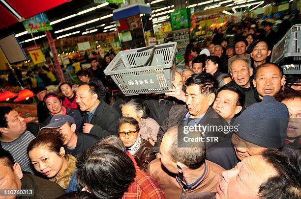 In a picture taken on March 17, 2011 Chinese shoppers crowd a shop in an effort to buy salt in Lanzhou, northwest China's Gansu province. Chinese...