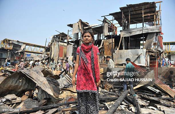 Indian child actress Rubina Ali who played the young Latika in the Oscar-winning film Slumdog Millionaire stands in front of her gutted makeshift...
