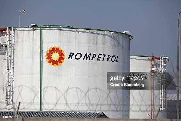 Oil storage tanks, operated by Rompetrol, stand near a gas station in Bucharest, Romania, on Thursday, March 24, 2011. Romania is unlikely to accept...