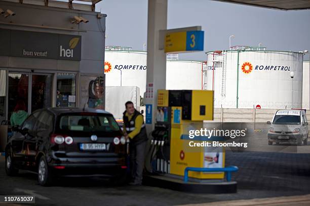 Oil storage tanks stand behind a Rompetrol gas station in Bucharest, Romania, on Thursday, March 24, 2011. Romania is unlikely to accept an offer by...