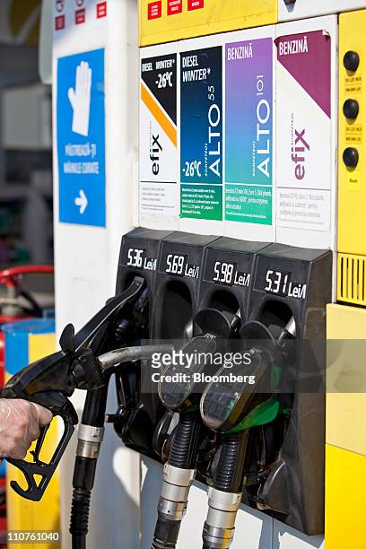 Customer selects a fuel pump at a Rompetrol gas station in Bucharest, Romania, on Thursday, March 24, 2011. Romania is unlikely to accept an offer by...
