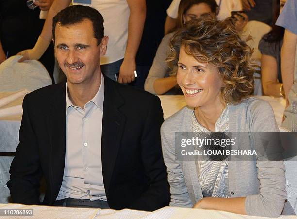 Syrian President Bashar Assad and his wife Asma visit a group of young athletes of special needs gathered at a hotel in Damascus late on September 5...