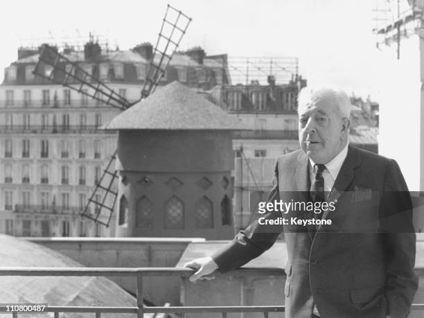 Popular French poet and songwriter Jacques Prevert poses near the Moulin Rouge in Paris, circa 1977.