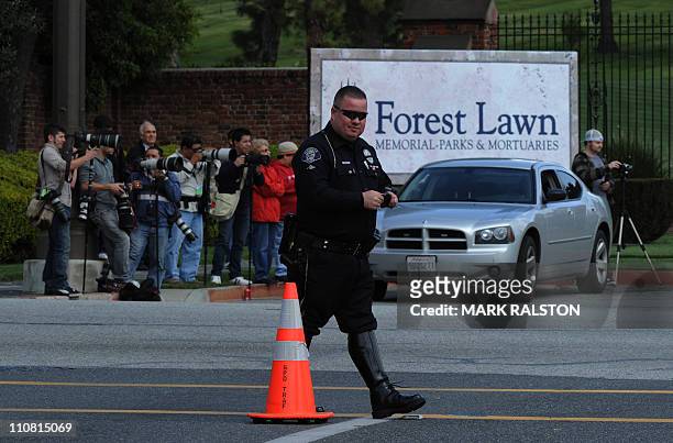 Family members arrive at the Forest Lawn Memorial Park in Glendale, California for the funeral of screen legend Elizabeth Taylor, March 24, 2011....