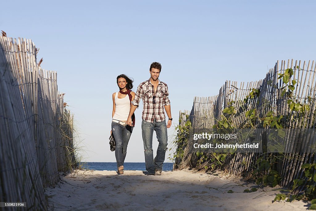 Young couple walking on beach