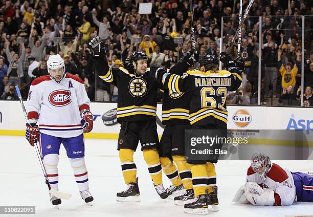 Gregory Campbell of the Boston Bruins celebrates his goal with teammate Brad Marchand as Carey Price and Tomas Plekanec of the Montreal Canadiens...