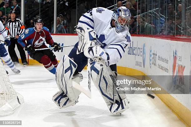 Goaltender James Reimer of the Toronto Maple Leafs fires the puck around the boards as Ryan Stoa of the Colorado Avalanche looks on at the Pepsi...