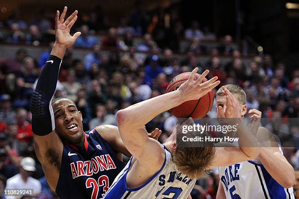 Derrick Williams of the Arizona Wildcats draws contact against Kyle Singler of the Duke Blue Devils during the west regional semifinal of the 2011...