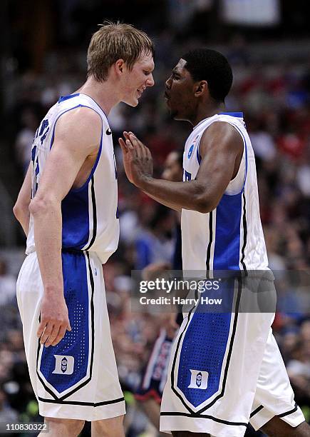 Kyle Singler and Kyrie Irving of the Duke Blue Devils celebrate after a play against the Arizona Wildcats during the west regional semifinal of the...