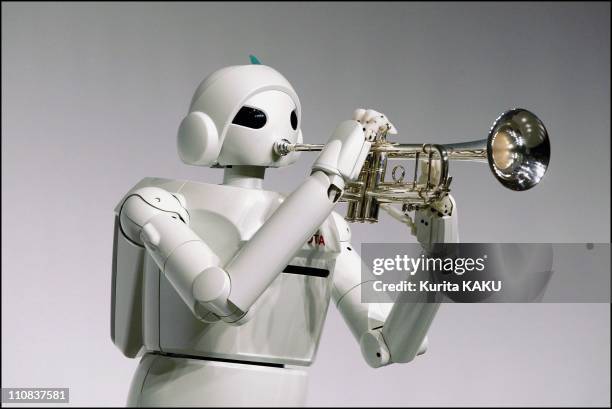 Toyota Motor Corporation Unveils Human-Assisting Partner Robots In Tokyo, Japan On March 11, 2004 - The robots play trumpets - The walking model...
